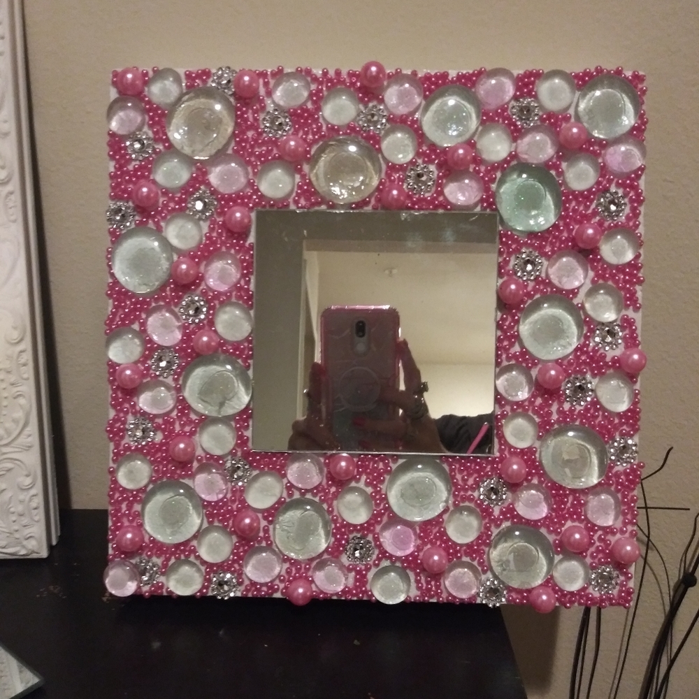 Wall Decor mirror surrounded in a sea of pink